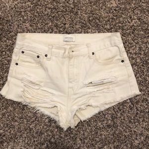 White, slightly high waisted jean shorts with rips